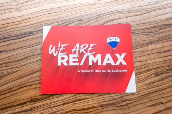 Business card which reads, "We are RE/MAX - a Business That Builds Businesses"